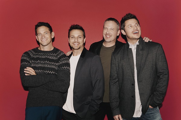 Members of the  band 98 Degrees stand against a wall