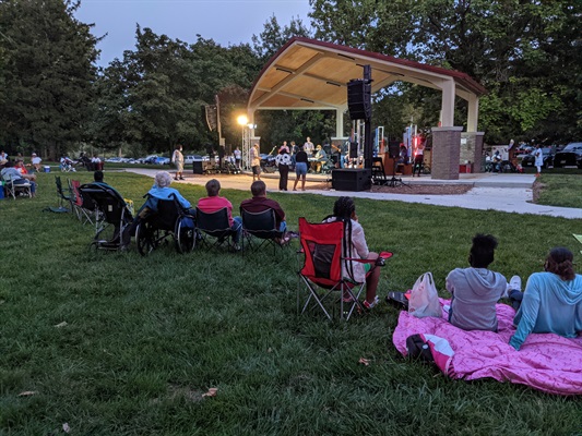 Attendees sit on blankets and lawn chairs to enjoy an evening with Big Wade & Black Swan Theory