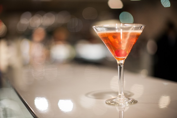 sparkling orange martini sits on the bar at Ovations
