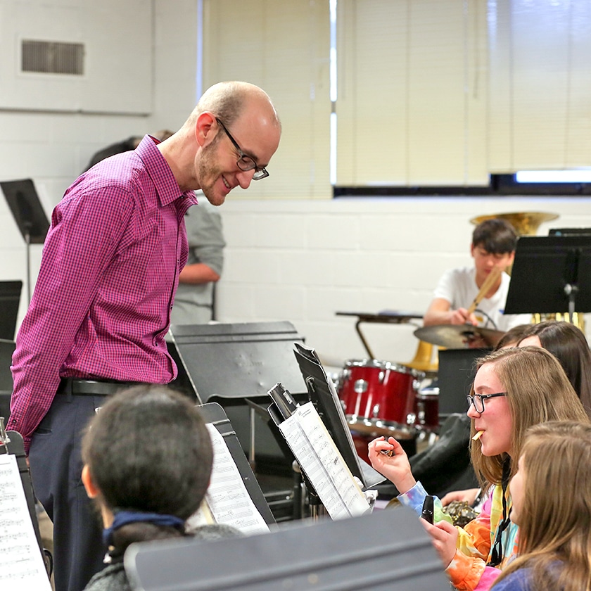 Shawn Bell teaching students in a school music room