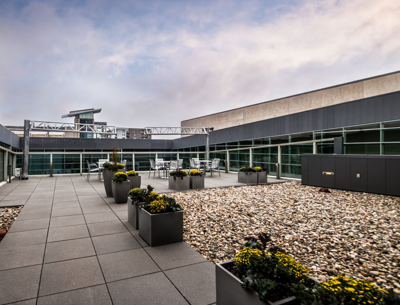 terrace a top the holladn center with rock landscaping, tables, and plants