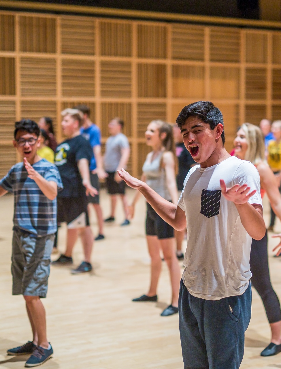 Students participating in a singing and dancing workshop