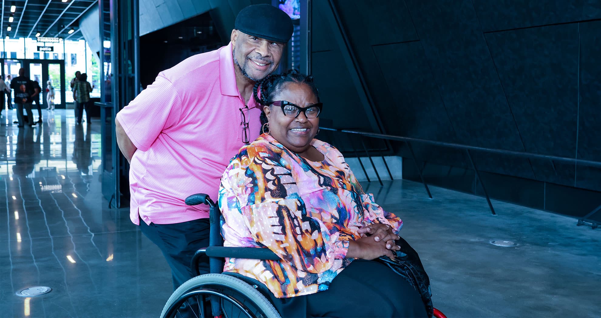 Couple at Steelhouse smiling widely. The woman in a wheelchair.