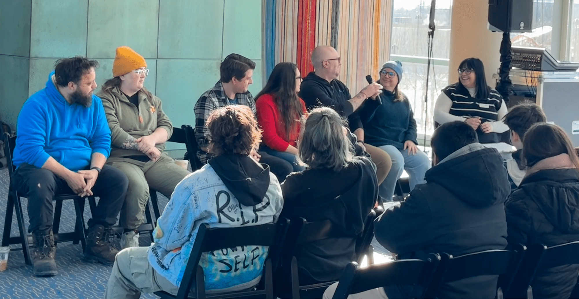 6 panelists speaking to a group of students